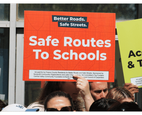 Better Roads, Safe Streets submits over 32,000 signatures to advance transportation measure Advocate of Better Roads Safe Streets holds up a sign "Safe Routes To Schools" outside of the Fresno County Elections Office during press event announcing the submission of over 32,000 signatures to advance transportation measure toward November ballot