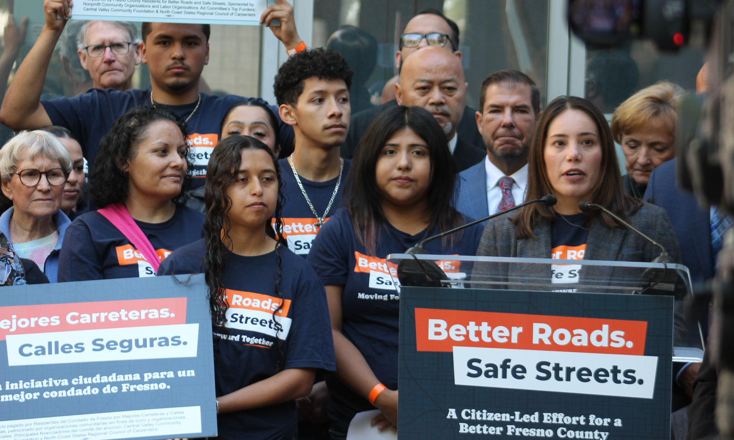 Better Roads, Safe Streets submits over 32,000 signatures to advance transportation measure Veronica Garibay speaking to public during press event announcing the submission of over 32,000 signatures to advance Better Roads Safe Streets transportation measure toward November ballot