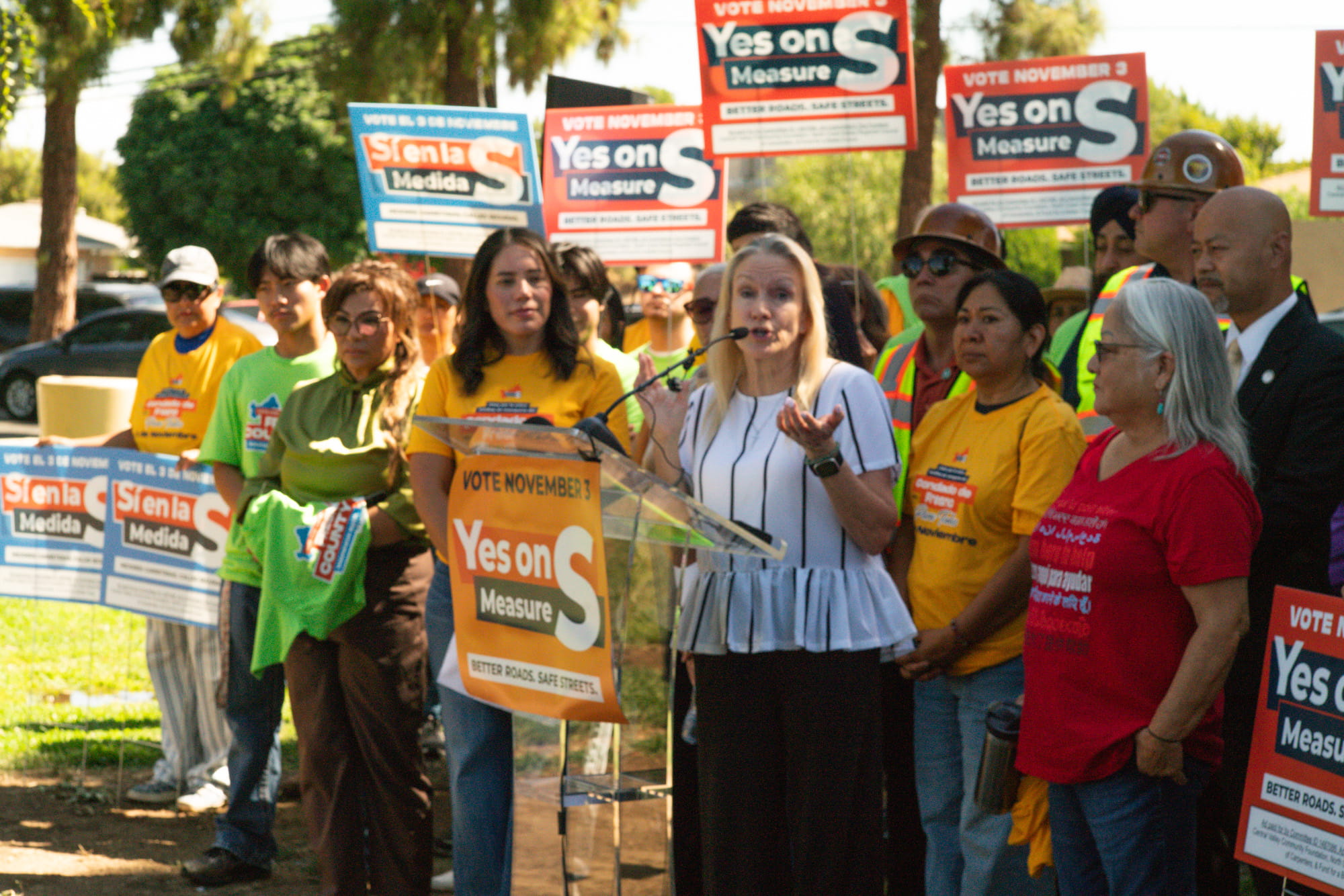 Woman addresses Fresno County voters at a Measure S event supporting safer roads, local jobs, and transportation options for every generation.